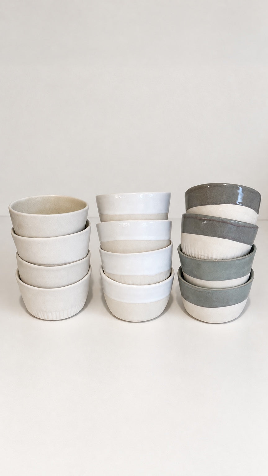 Agora ceramic cups stacked in three finishes: Original Agora, Agora White and Sage