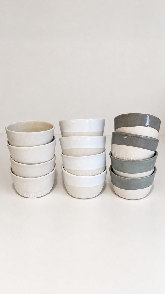 Agora ceramic cups stacked in three finishes: Original Agora, Agora White and Sage
