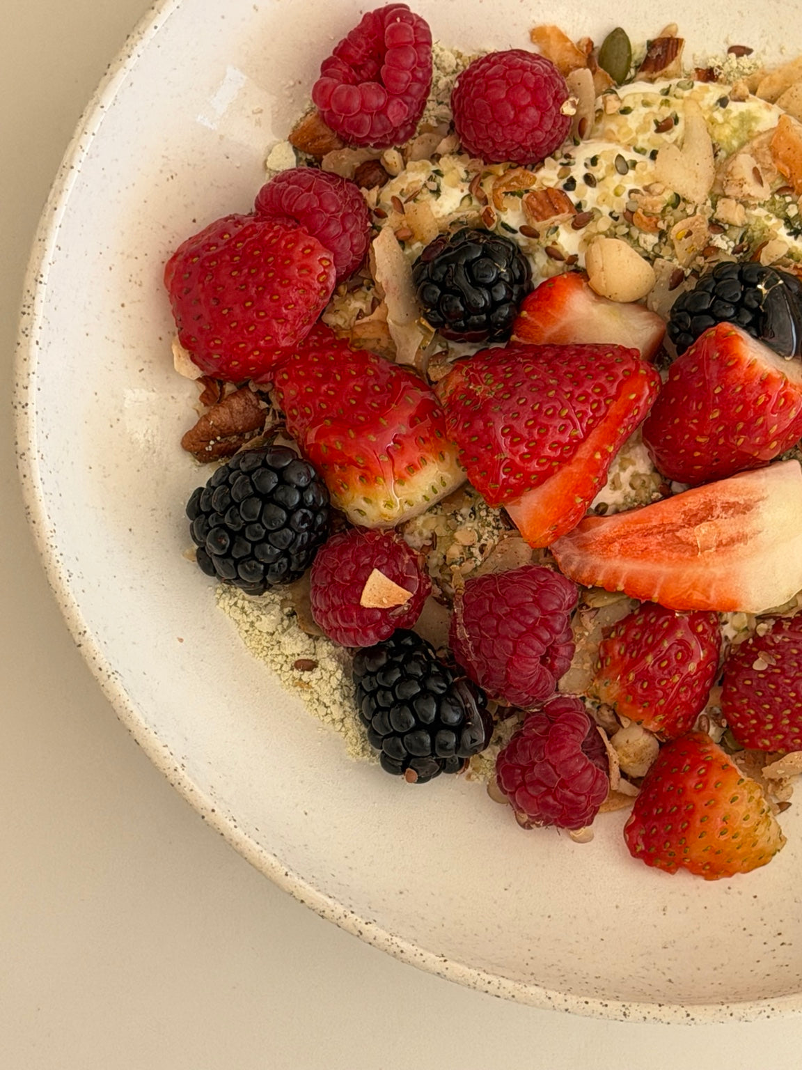 Close-up of fresh berries and granola served in a handmade Petra Bowl